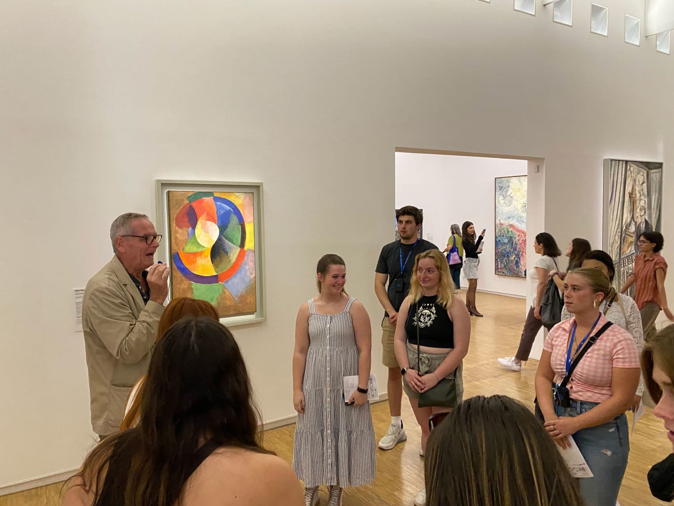 A group of students on a tour in an art museum.