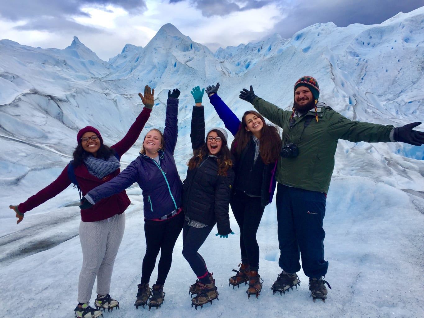A group of students posing with snowy mountains in the background in Argentina.