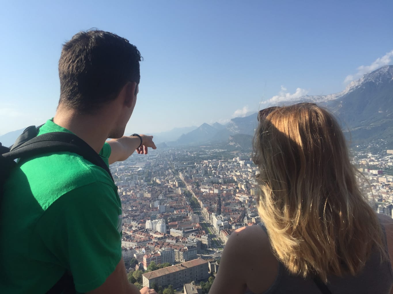 Two students on top of a mountain overlooking Grenoble, France.
