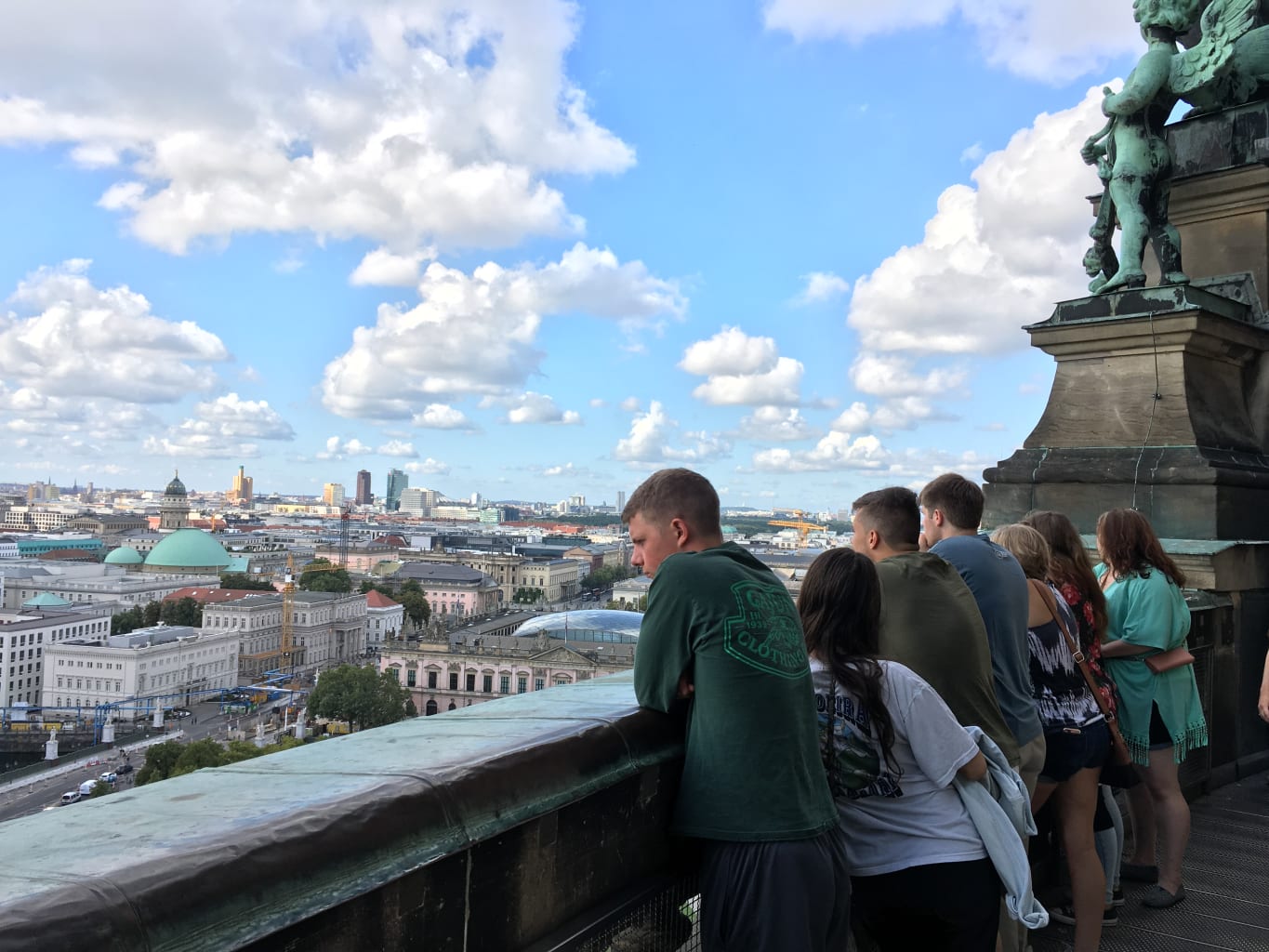 A group of students looking at an aerial view of a city.