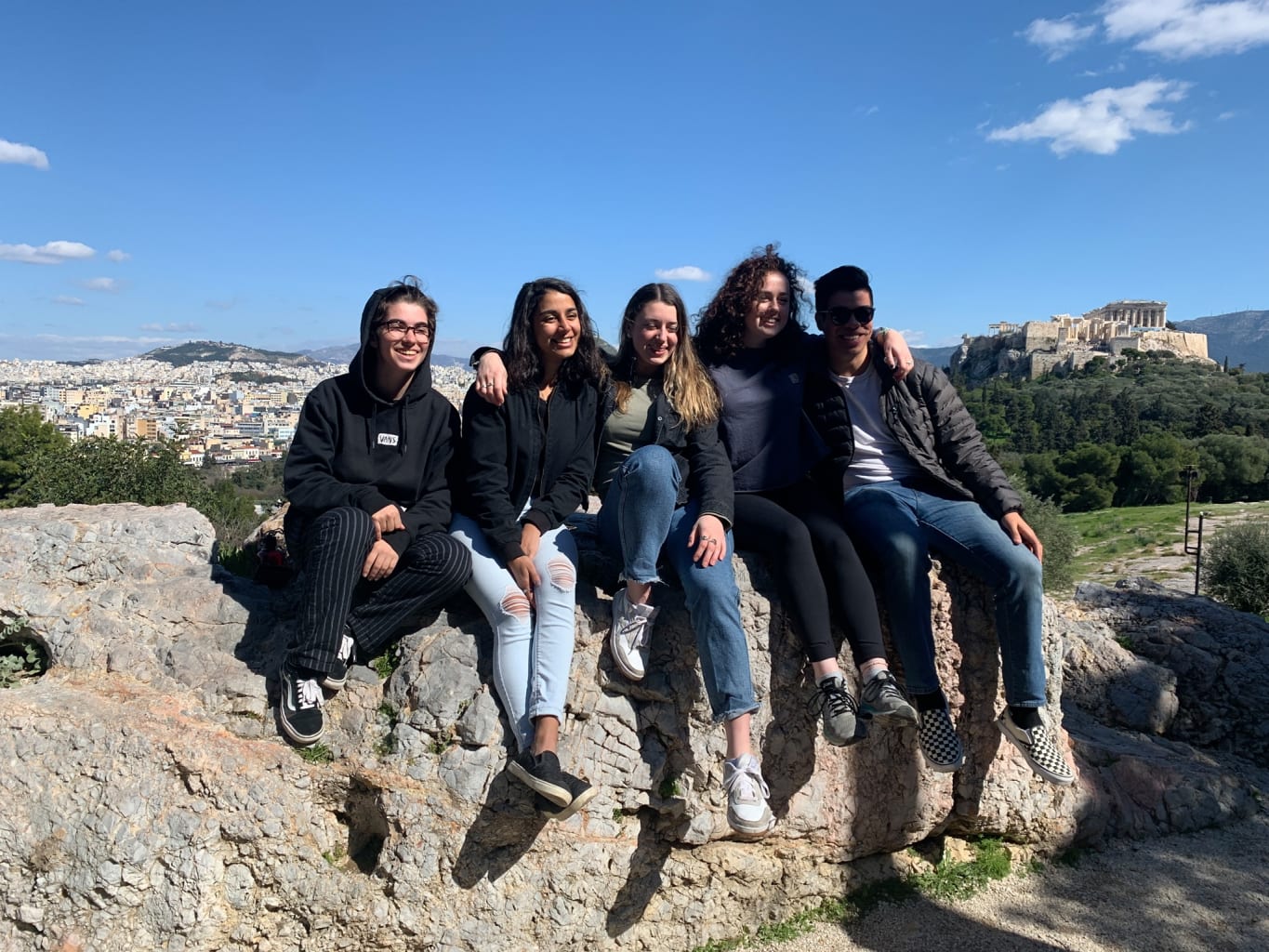 Group of students sitting on a wall in Athens.