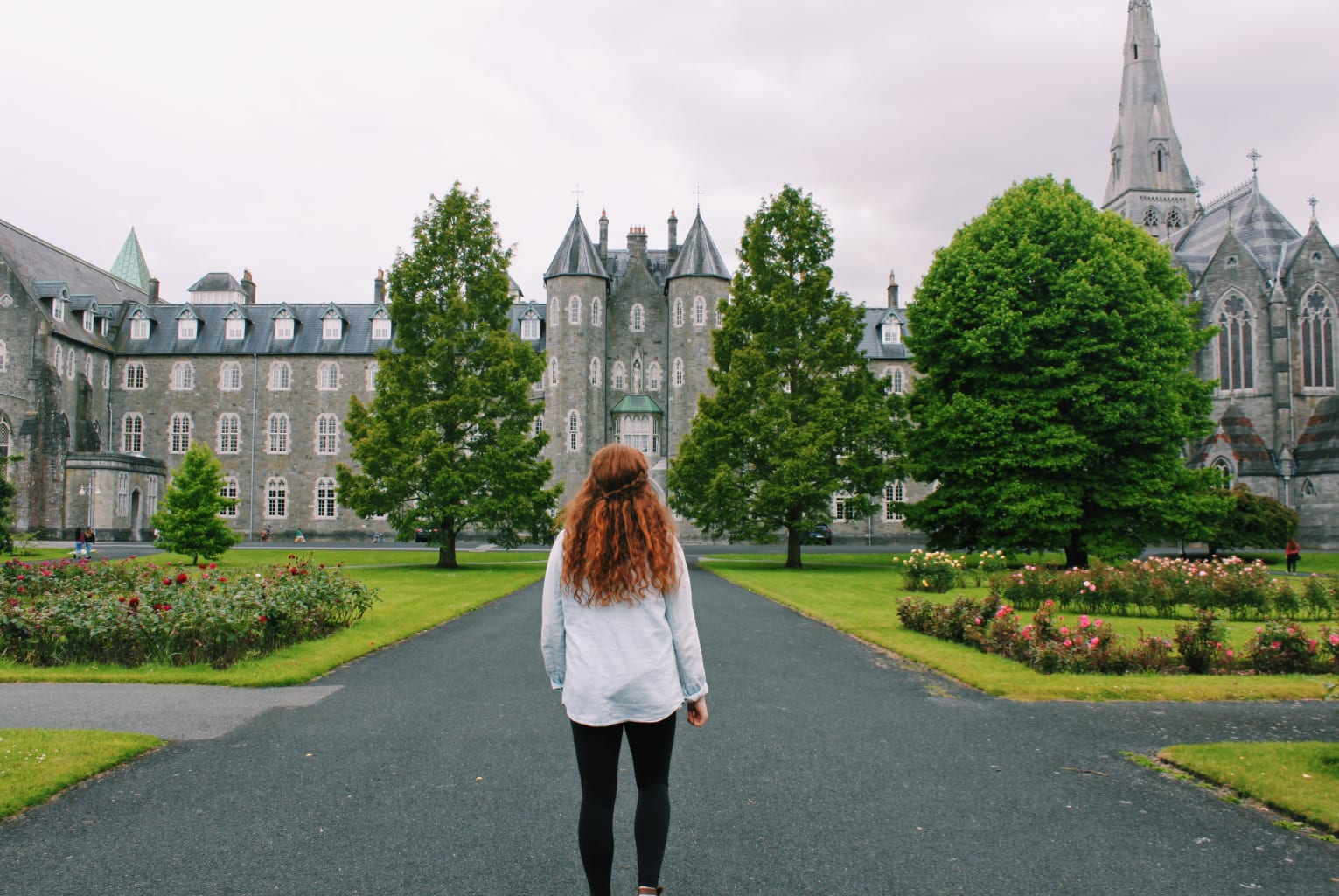 A student standing in a courtyard in Maynooth, Ireland.