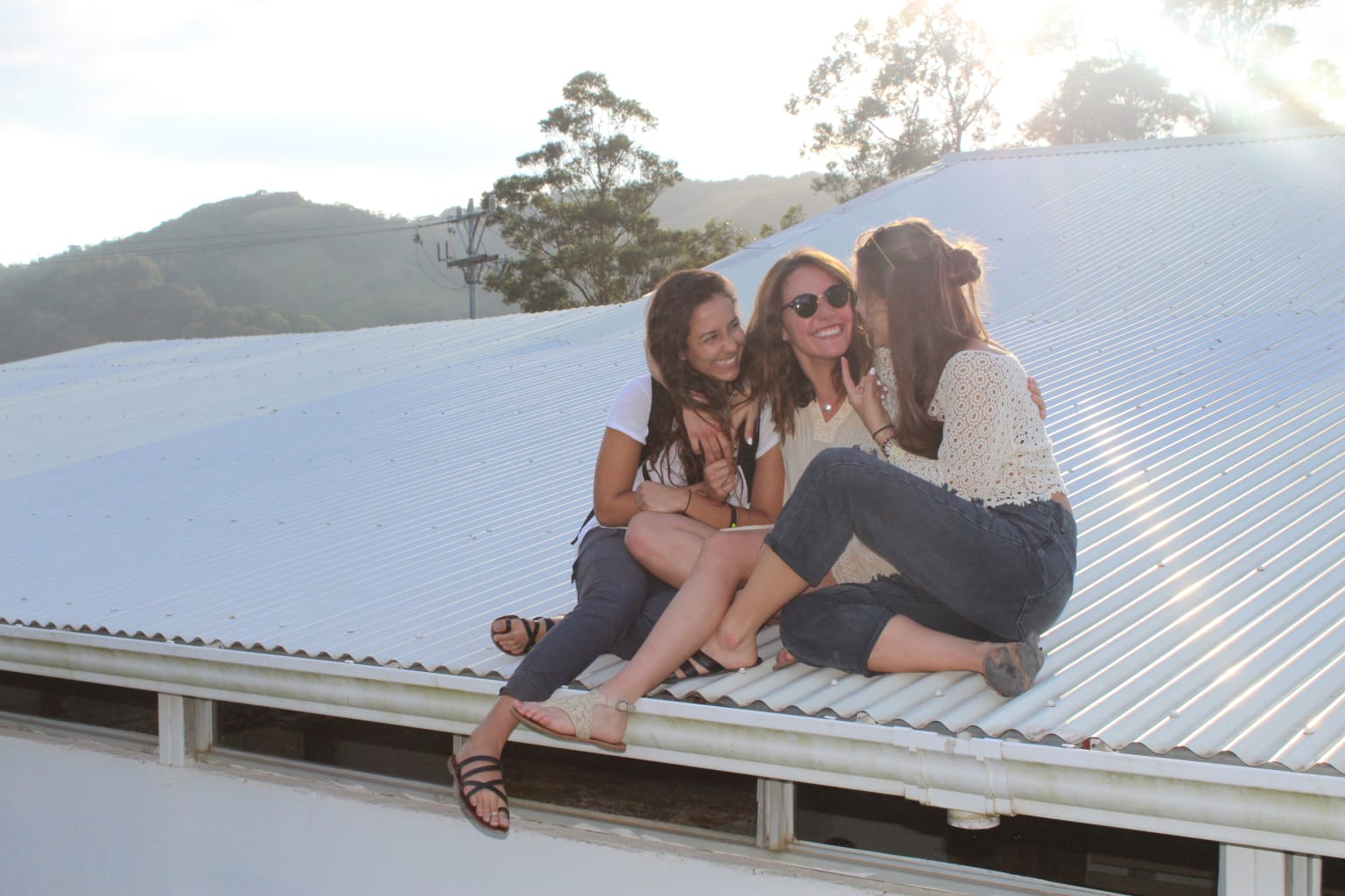 Three students sitting on a roof in Costa Rica.