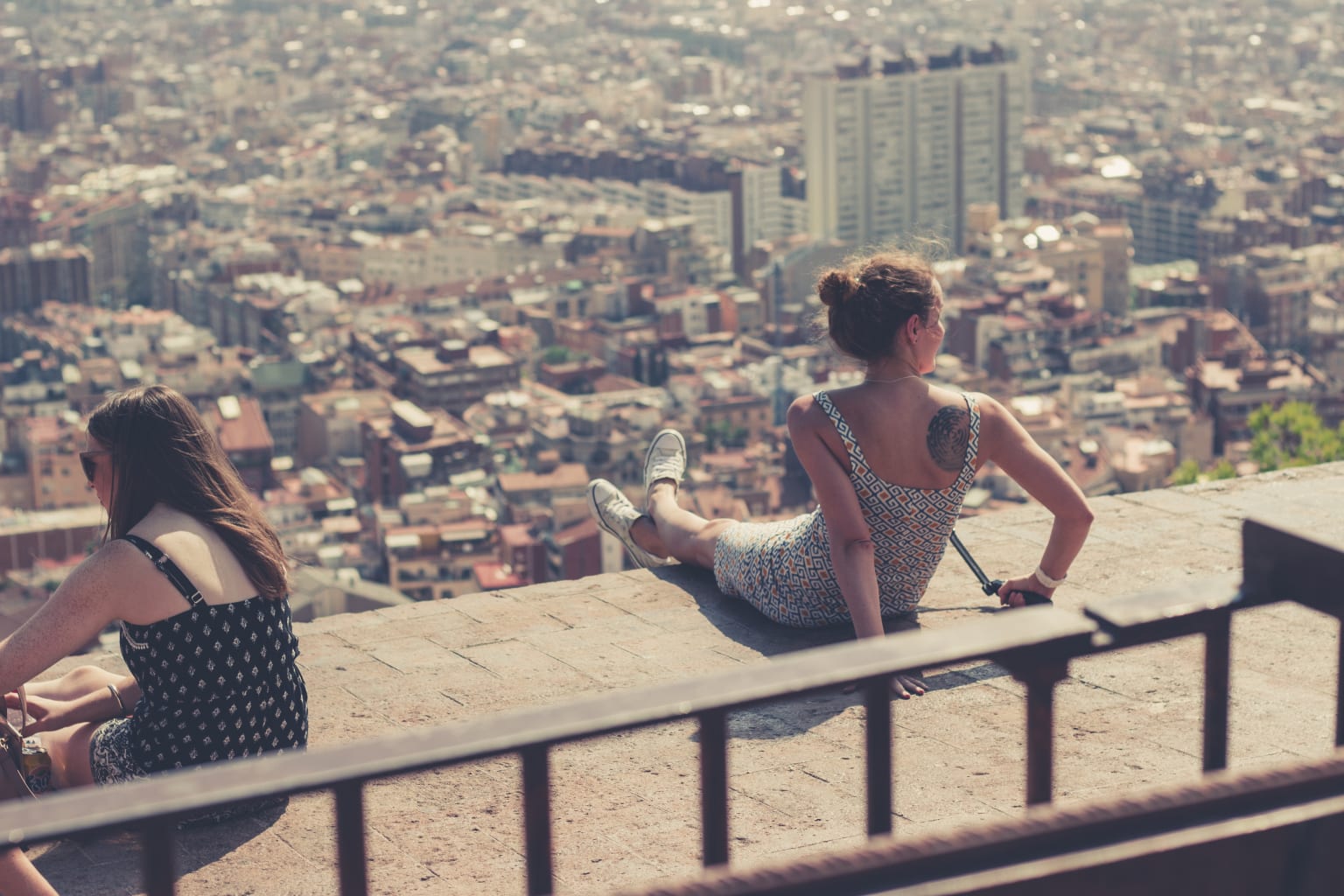 Girls sitting on ledge.