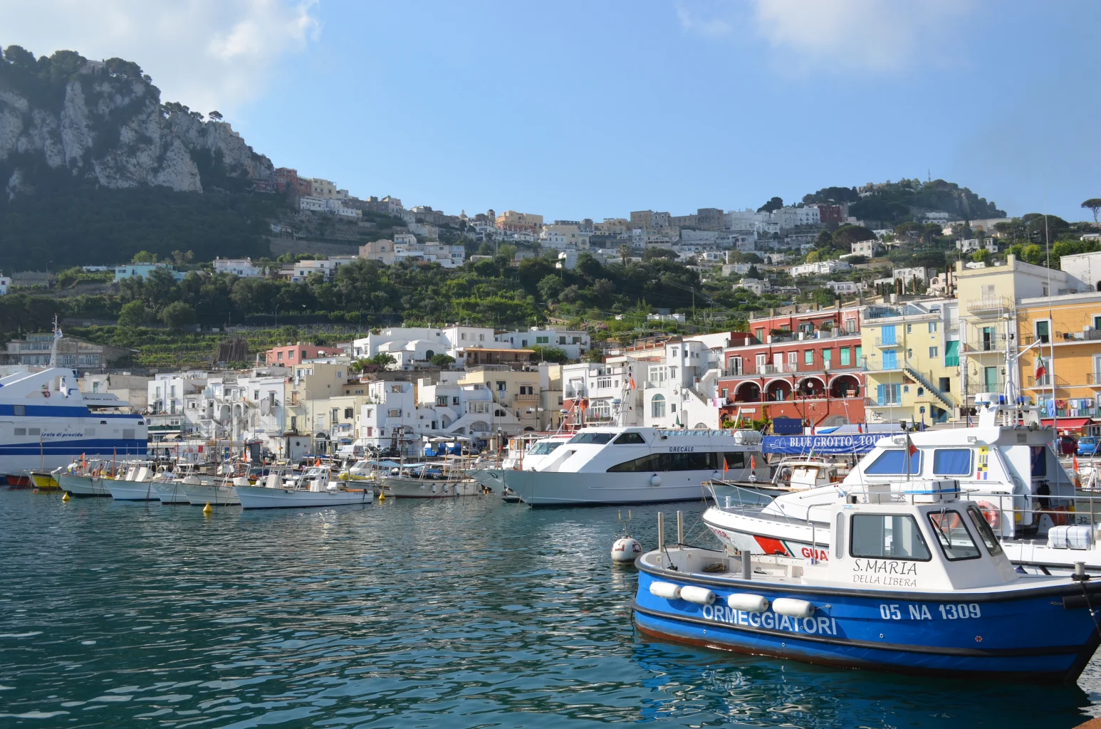 Boats and colorful buildings on the coast of Italy.