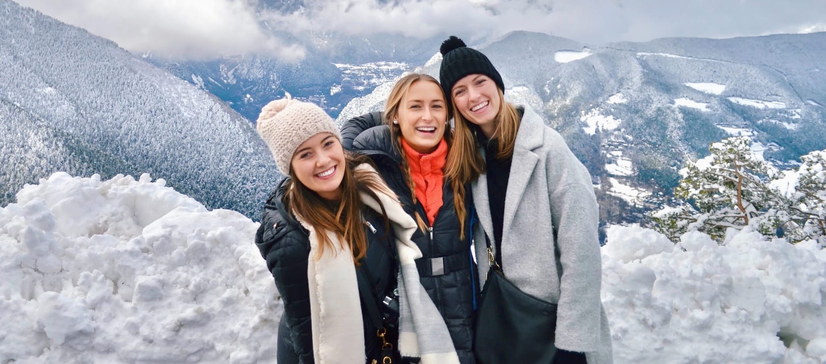 Three students at the top of a mountain in Spain.