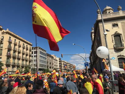 A crowd in Barcelona waving Spanish flags.