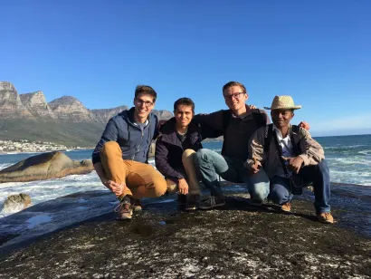 A group of students posing on a rock on the coasts of South Africa.