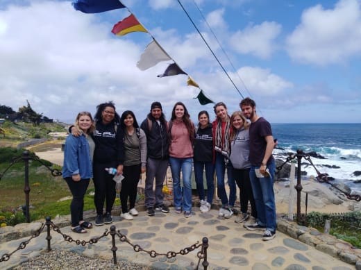 A group of students with an ocean view in the background in Chile.