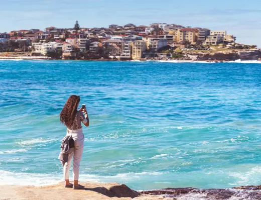 A student admiring an ocean view in Sydney, Australia.