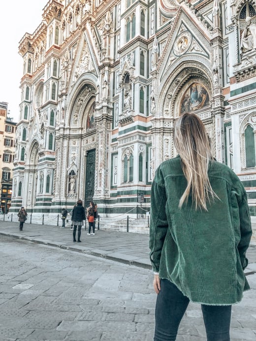 A student walking near the Cathedral of Santa Maria del Fiore in Florence, Italy.