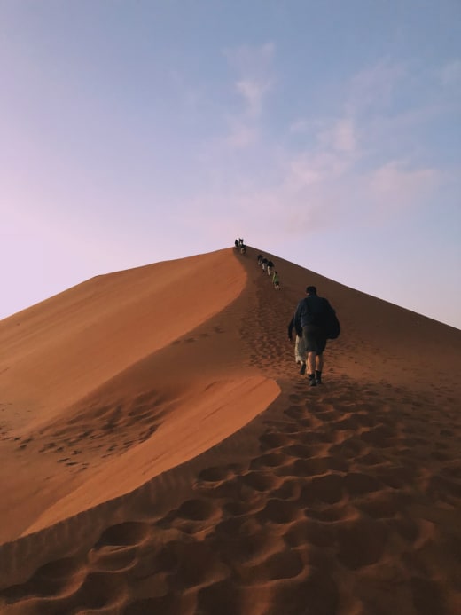 Boy walking in desert.