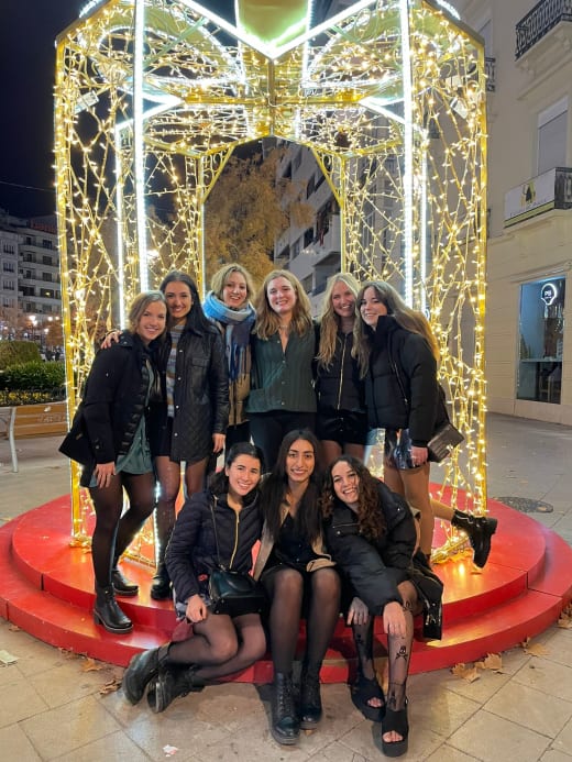 Girls posing in front of lights.