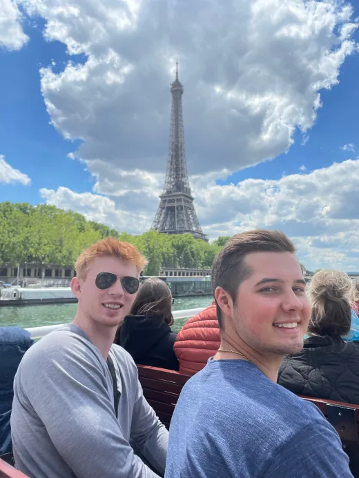 Students on a boat tour passing by the Eiffel Tower.