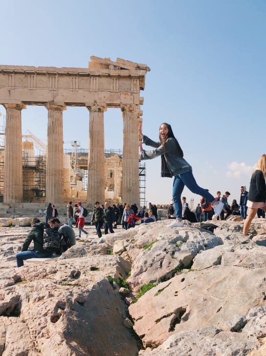 A student posing in front of the Parthenon.