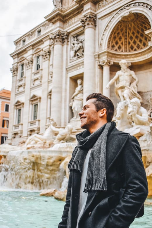 A student in front of the Trevi Fountain in Rome, Italy.