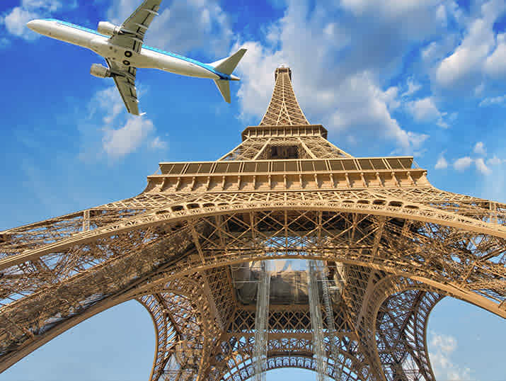 Plane flying over the Eiffel Tower in Paris, France.