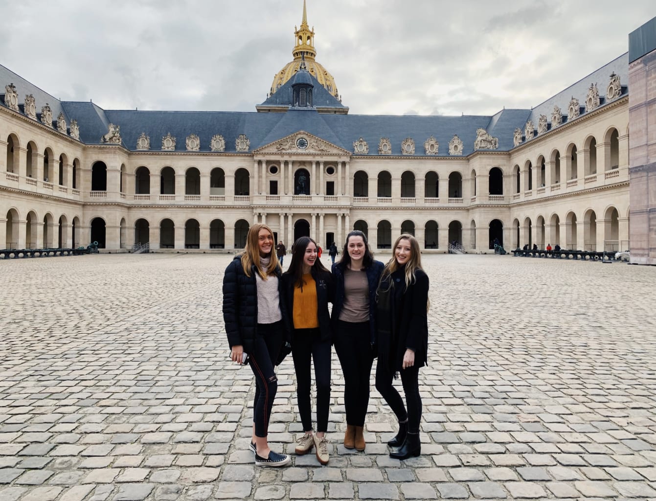 Four students in front of a building in France.
