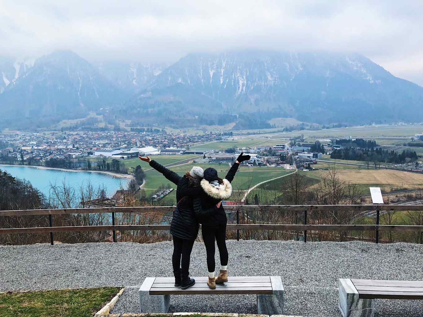 Two students posing in front of a mountain landscape in Italy.
