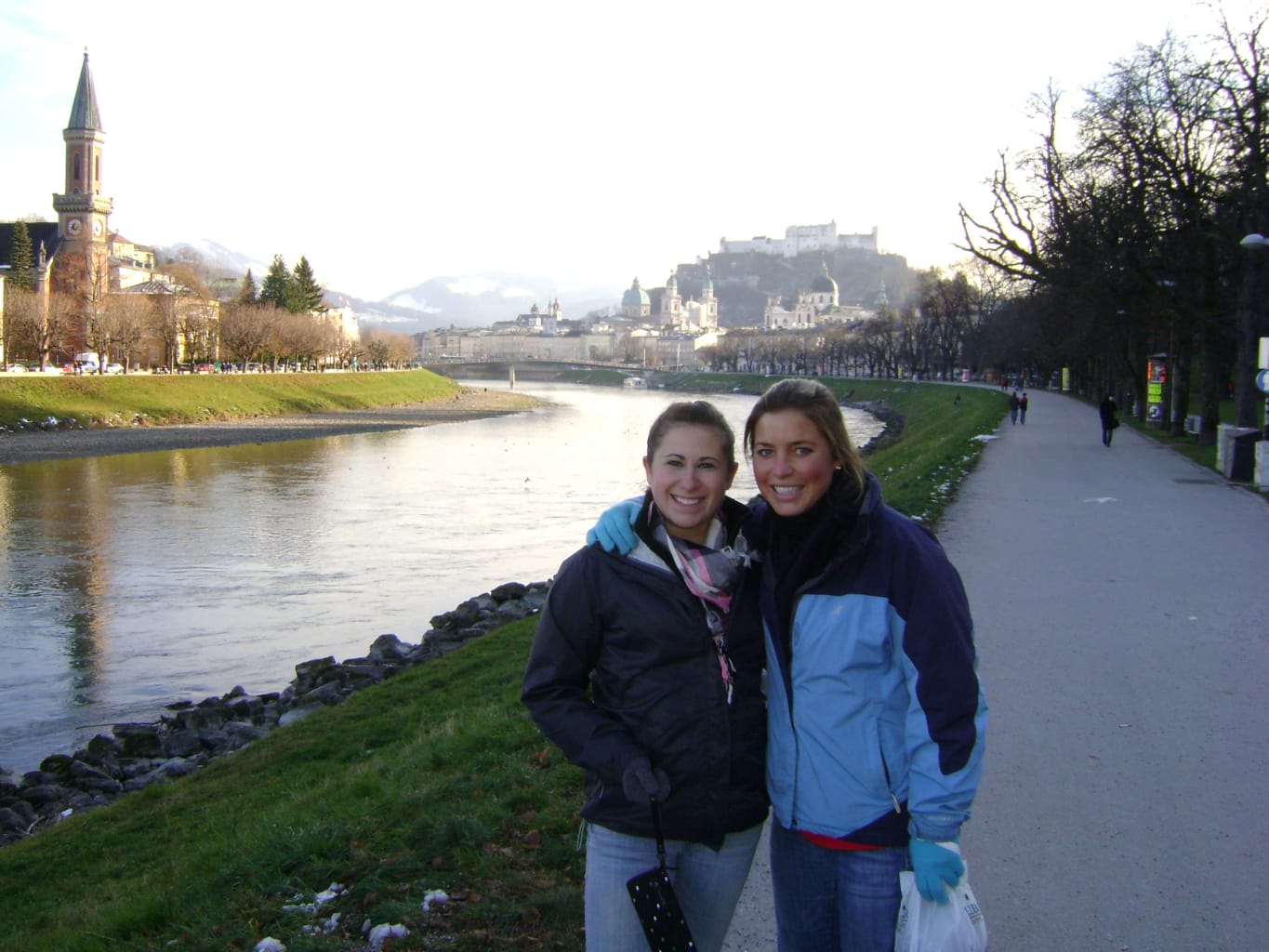 Two women by a scenic river in Salzburg, Austria.