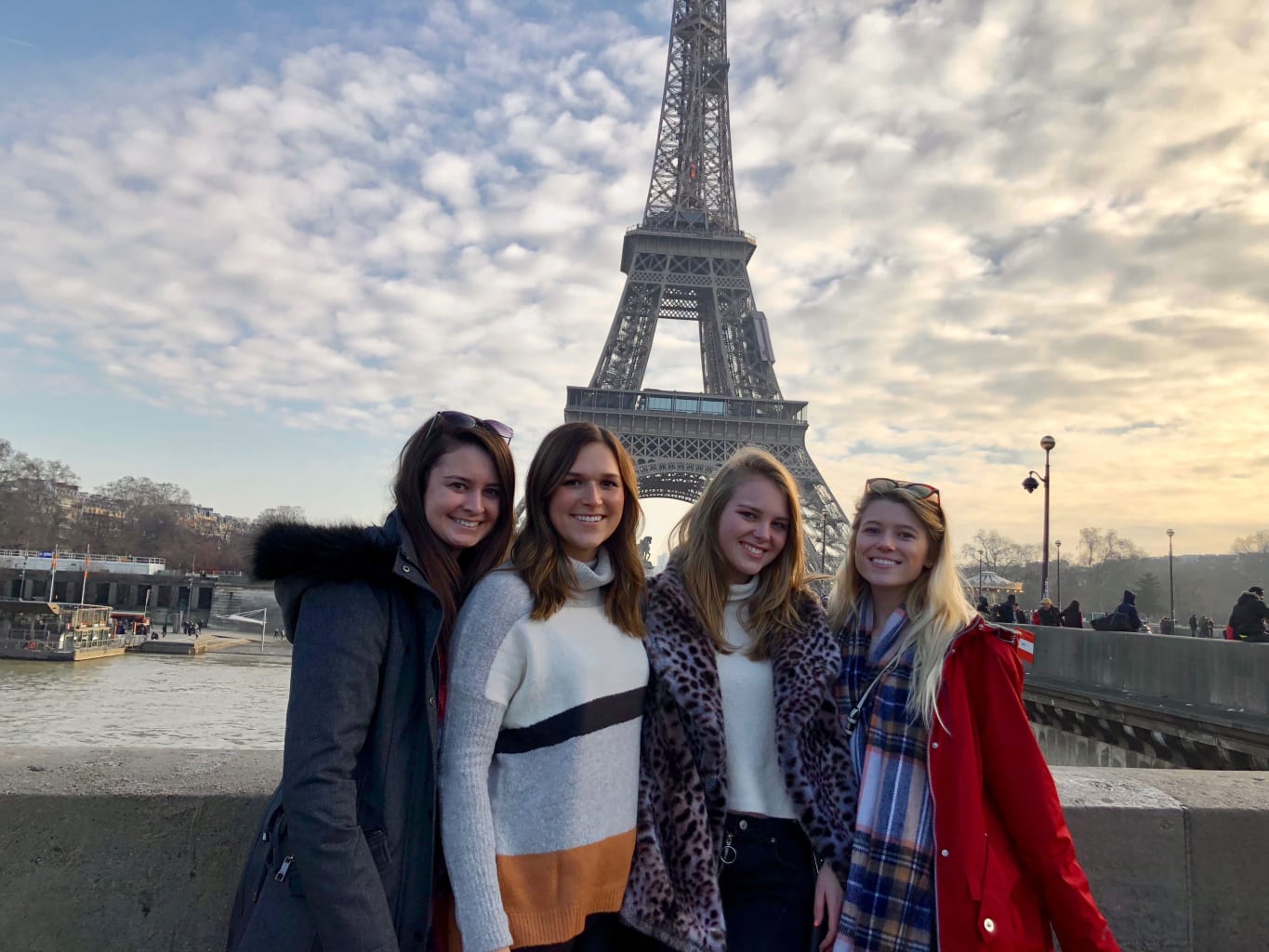 Four women in front of the Eiffel Tower in Paris.