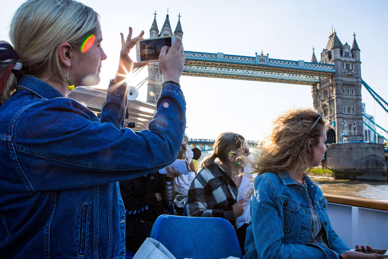 Woman taking a picture of Tower bridge in London.