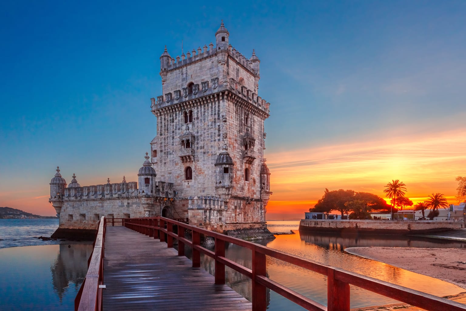 Belém Tower with a sunset in the background.