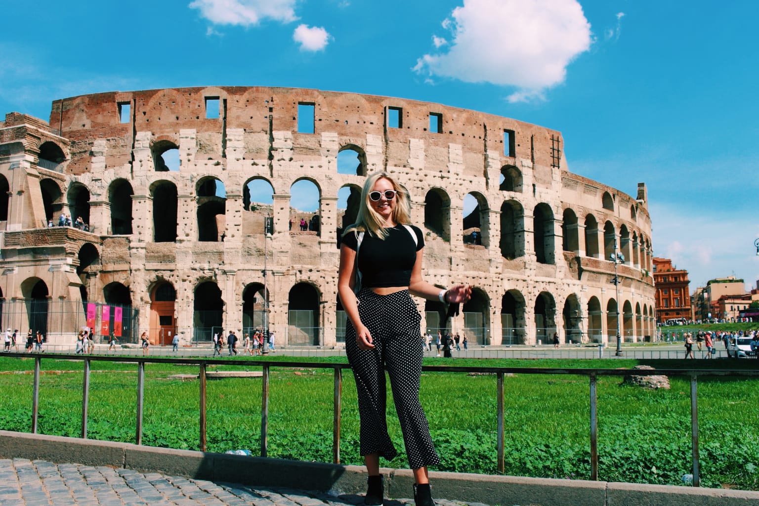 A student posing in front of the Colosseum in Rome, Italy.
