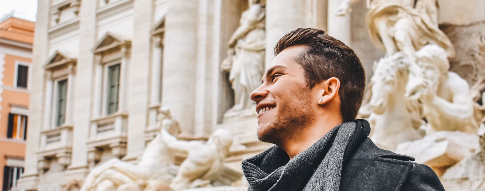 Student in Rome in front of Trevi fountain.