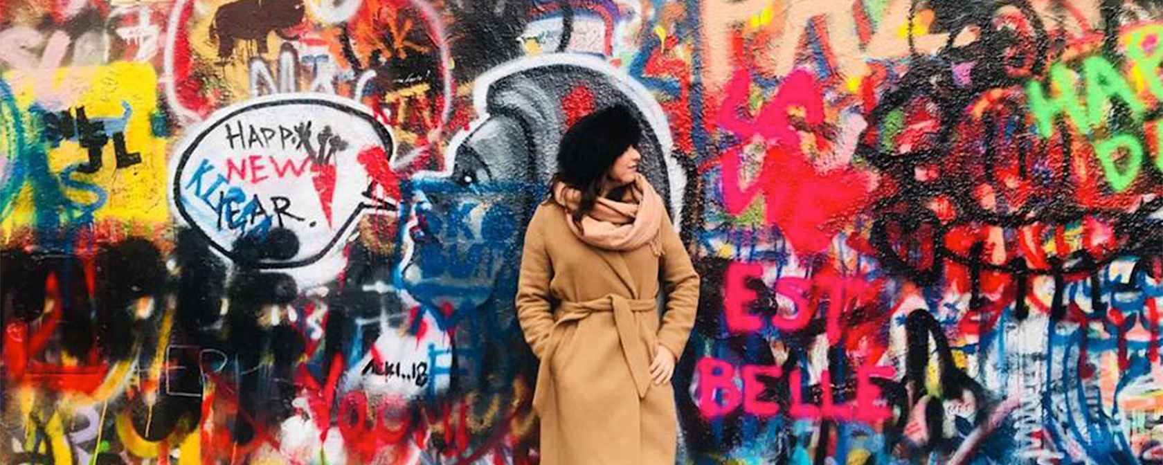 AIFS Abroad in Prague student in front of a graffiti wall.