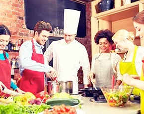 A chef teaches culinary techniques to students.