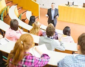 A professor lectures to a group of students.