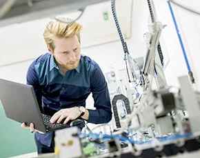 Young engineer inspects project.