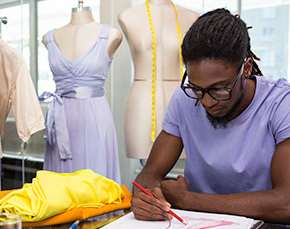 Fashion designer sketches dress designs