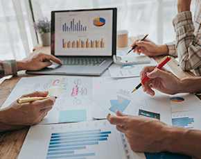 Finance professionals study financial charts.