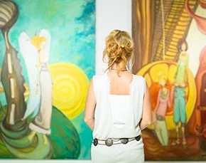 Woman studying artwork in a museum