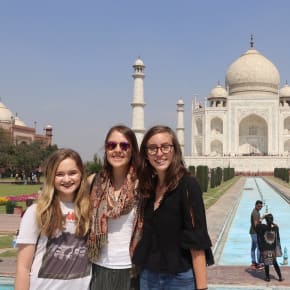 Three students in front of the Taj Mahal in India.