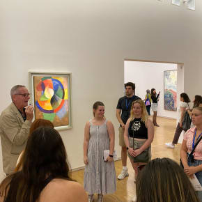 A group of students on a tour in an art museum.