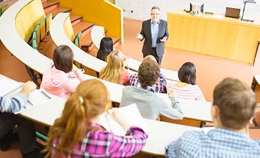 A professor lectures to a group of students.