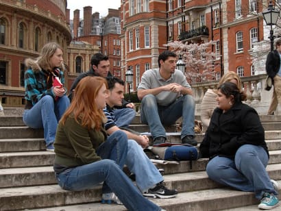 Students sitting on steps outside in London.