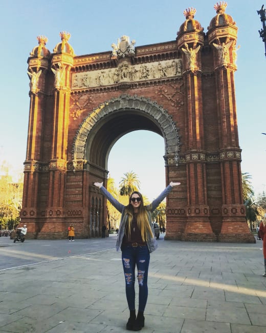Girl standing in front of arch.