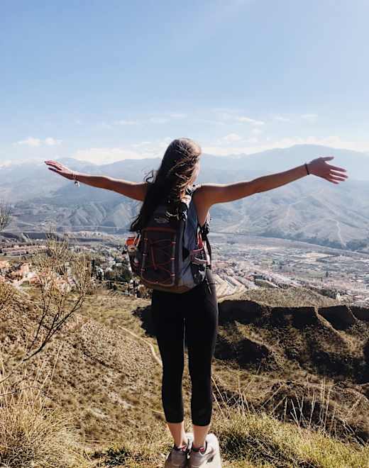 Girl with her arms out posing.