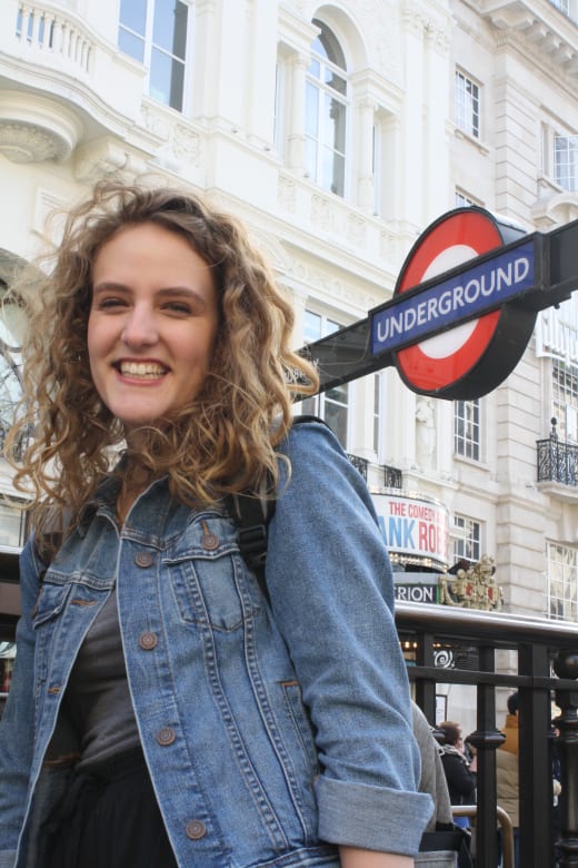 A student in front the London Underground sign.
