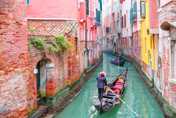 A person rowing a gondola in Venice.