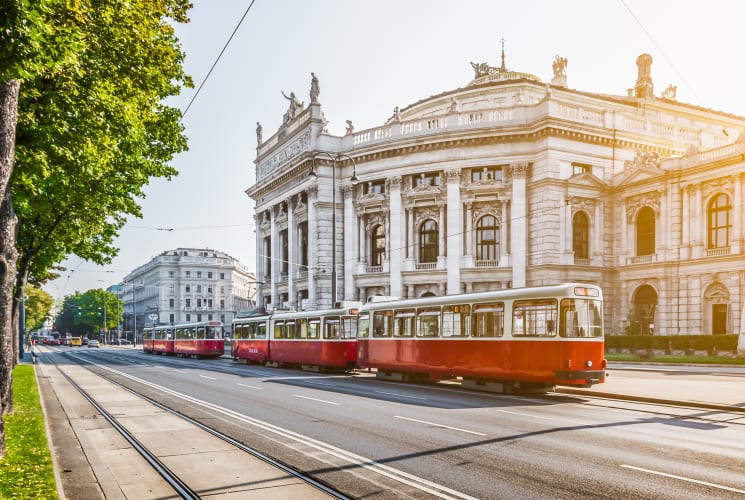 Red trolleys on a street in Vienna.