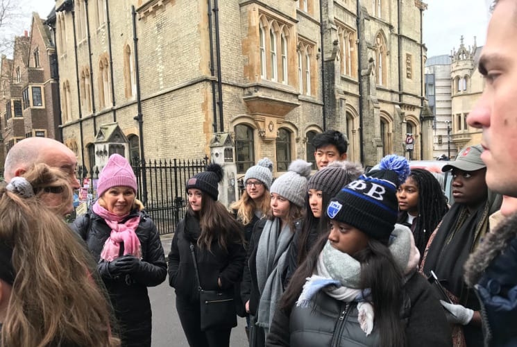 A group of students listening to a staff member in London.