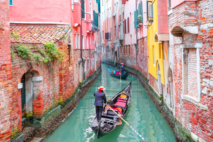 A person rowing a gondola in Venice.