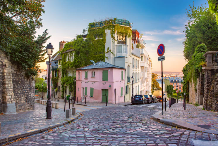 A street in Paris with a pink building.