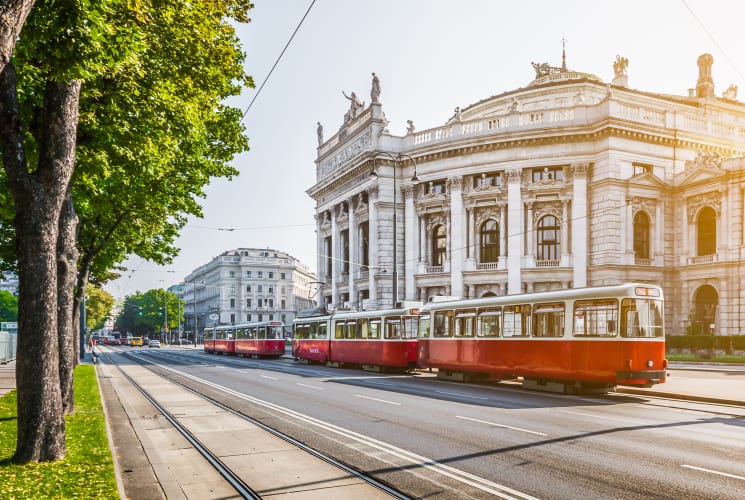 Red trolleys on a street in Vienna.
