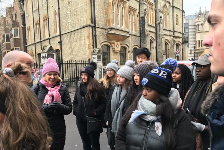 A group of students listening to a staff member in London.
